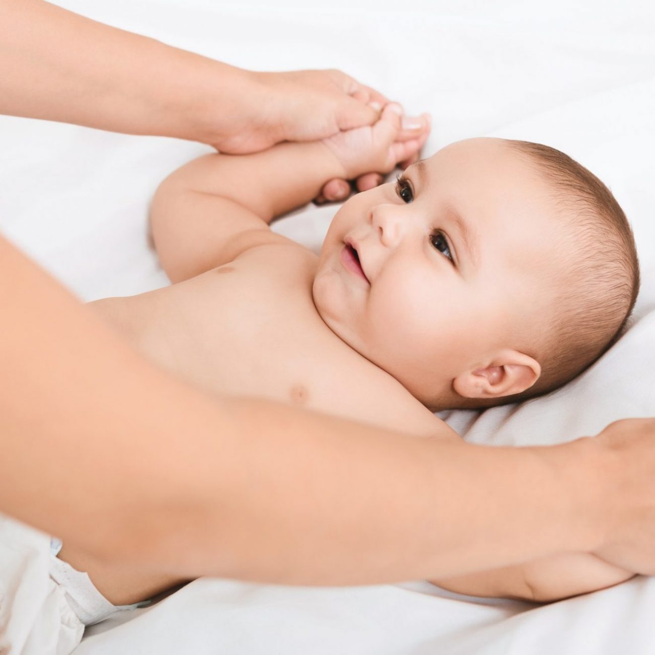 mother-massaging-and-doing-gymnastic-to-her-kid.jpg