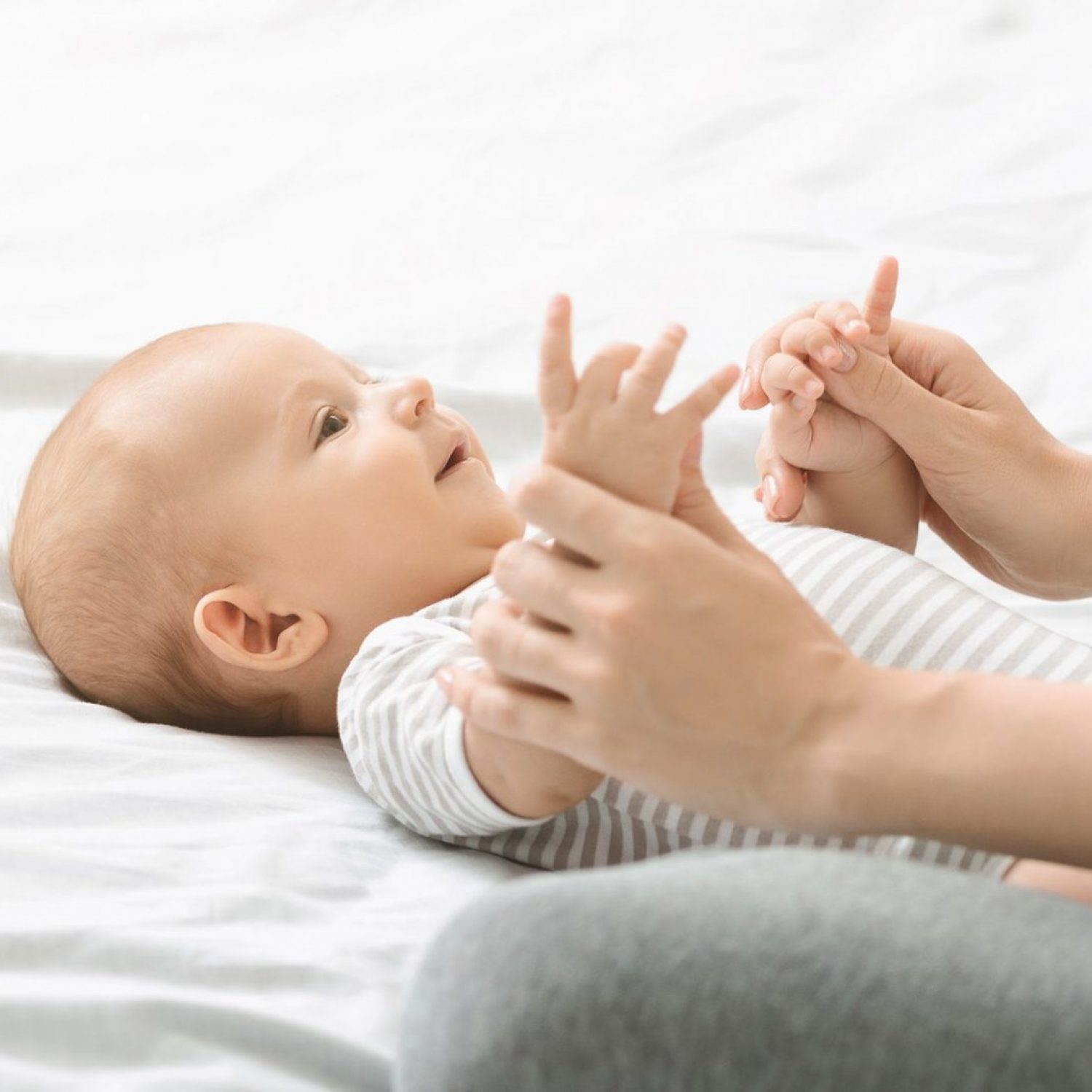 mother-massaging-cute-newborn-baby-doing-exercises-for-his-development.jpg